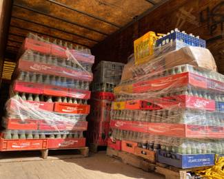 Many crates full of bottles. Will be sold by the crate.