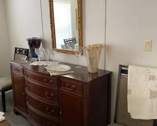 Nice mahoghany buffet and beautiful gold mirror.