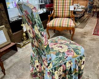 Lot #28: Iron and wicker glass topped table with four floral upholstered Parsons chairs on casters