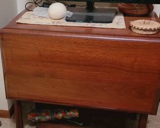 Small drop-leaf table, assorted boxes, TV.