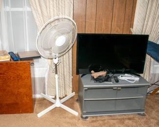 Samsung TV, tv stand, fan, wood hamper.