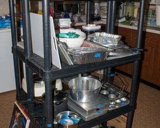 Kitchen items, pots, pans, drink pitchers, serving platters, baking pans, cutting boards.