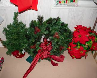 Christmas wreath, tree, flowers in gold vase.