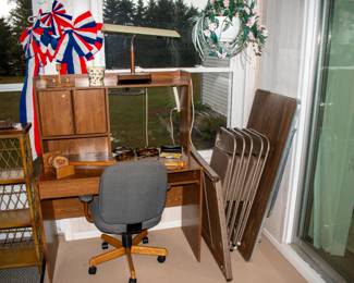Computer desk, office chair, desk lamp, couple folding tables, folding chairs, festive bows.