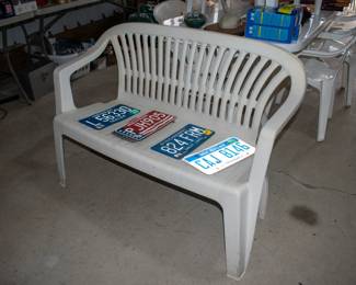Outdoor bench, license plates.