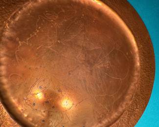 Hammered copper plate with acorn design.
