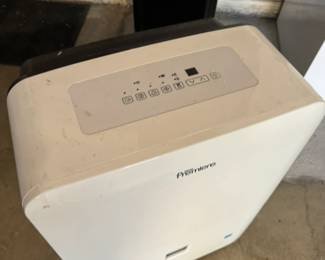 Premiere compact, portable dehumidifier with a control panel on the top for adjusting settings, such as fan speed, humidity levels, and power. The front includes a water collection tank.