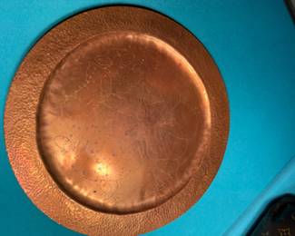 Hammered copper plate with acorn design.