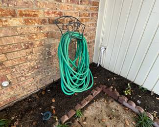 Garden items, including several hoses and reels.