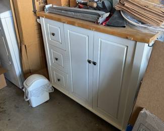 Rolling butcher block top kitchen island.
