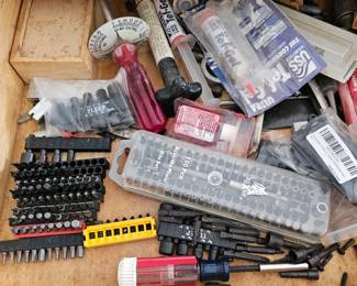 Various items within workbench including drill bits
