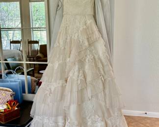Wedding gown designed by Lazaro. Size 14 but was altered down. Only worn one time! :)