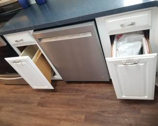 Dishwasher; kitchen cabinets feature two trash corrals