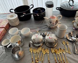 Tea cups, tea spoons , pita, coffee cups, sugar and cream containers 