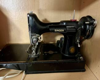 Singer Featherweight 
It works just fine!
Cord and pedal included 