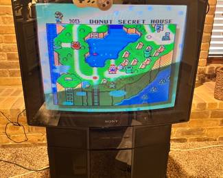 Super Nintendo plugged into TV to show that it works