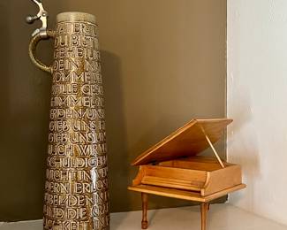 Tall stein with the Lords Prayer around it and musical box wooden shelf piano