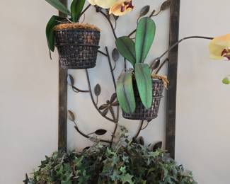 Hanging metal wall art with artificial flowers