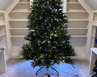 Very Tall.. So Tall the top portion doesn't fit on the tree in this room.. lit Christmas tree with storage bag