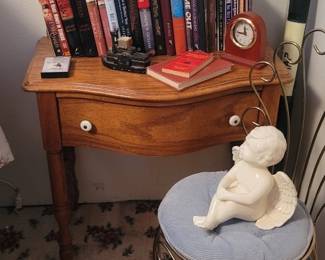Oak Pressed Back One Drawer Washstand Table, Assortment of Books, Mid Century Scrolled Brass-tone Vanity Chair, White Ceramic Cherub Statue