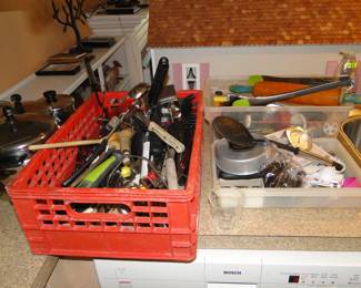 A whole crate of knives and kitchen implements.  Implements, that's a funny word.