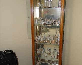 Mirrored curio cabinet with lots and lots and lots and lots and lots of figurines