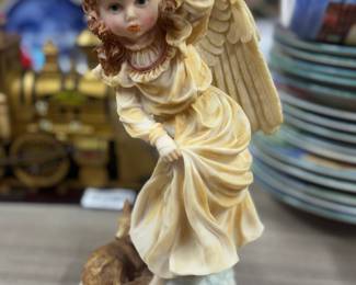 Retail $22. Our Price: $5. Delicate Angel Figurine. A charming angel in a flowing gown, perfect for any collector or as a thoughtful gift.