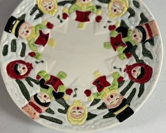 Retail $30. Our Price: $10. Carolers Plate by The Sirtata Group. Hand-painted ceramic plate featuring charming carolers, perfect for holiday decor.