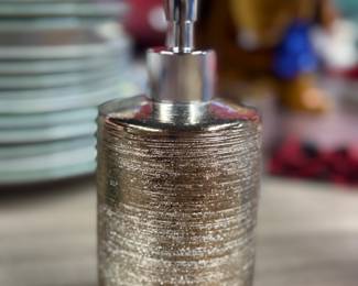 Retail $15. Our Price: $5. Gold Textured Soap Dispenser. Add a touch of elegance to your bathroom with this stylish and functional piece.