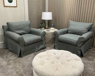 Pair of slip covered chairs and a large textured fabric hassock 