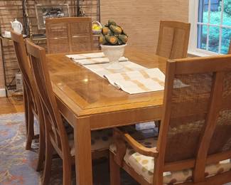 Lovely dining room with light oak dining table with 2 leaves and 6 cane back upholstered dining chairs