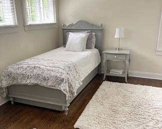 twin bed, linens, area rug
