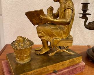 Cast Bronze Sculpture, seated girl reading with a lap dog, basket of fruit at feet, unsigned, 8 1/2 x 9 x 4 1/2 inches, circa late 19th century.