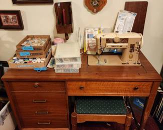 Singer sewing machine in a mid century cabinet