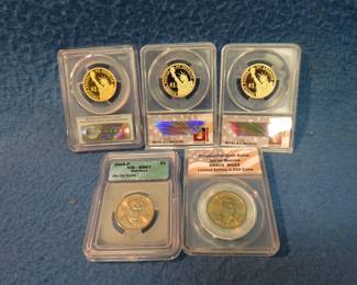 Lot 56. Five gold-colored graded Presidential Dollars