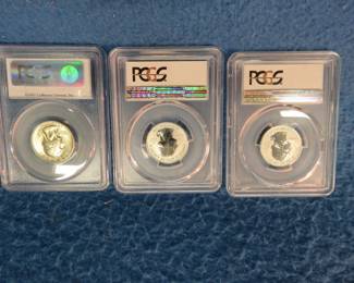 Lot 53. Three silver quarters graded