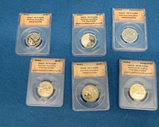 Lot 257. Six American Innovation $1 gold-colored coins slabbed and graded by ANACS as shown in the photographs