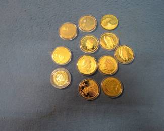 Lot 52. Mixed design dollar-size non-monetary gold-colored medallions including Donald Trump, Liberty, Constitutional themes