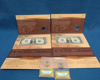 Lot 294. Two U.S. Mint American $1 Currency Sets each with a $1 note, but with the coins removed; and two 2014 D Native American Dollar Coins