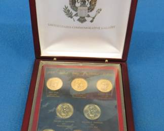 Lot 159. Display case with eight gold-colored Presidential dollar coins