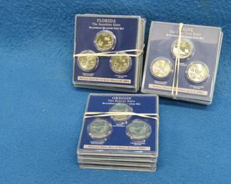 Lot 101. Fourteen State Quarter cards each from a different state and each containing one quarter from each of the three mints: 2003, 2004, and 2005.
