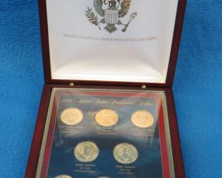 Lot 160. Display case with eight gold-colored Presidential dollar coins