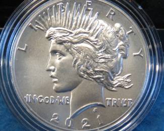 Lot 73. 2021 P high grade Peace Silver Dollar encapsulated in a presentation box