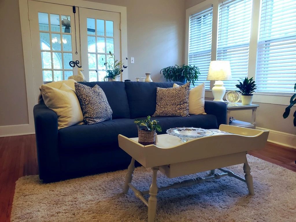 The blue sofa matches a chair in later photo