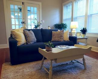 The blue sofa matches a chair in later photo