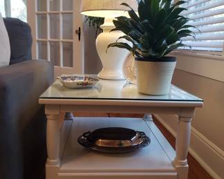 One of two matching white end tables