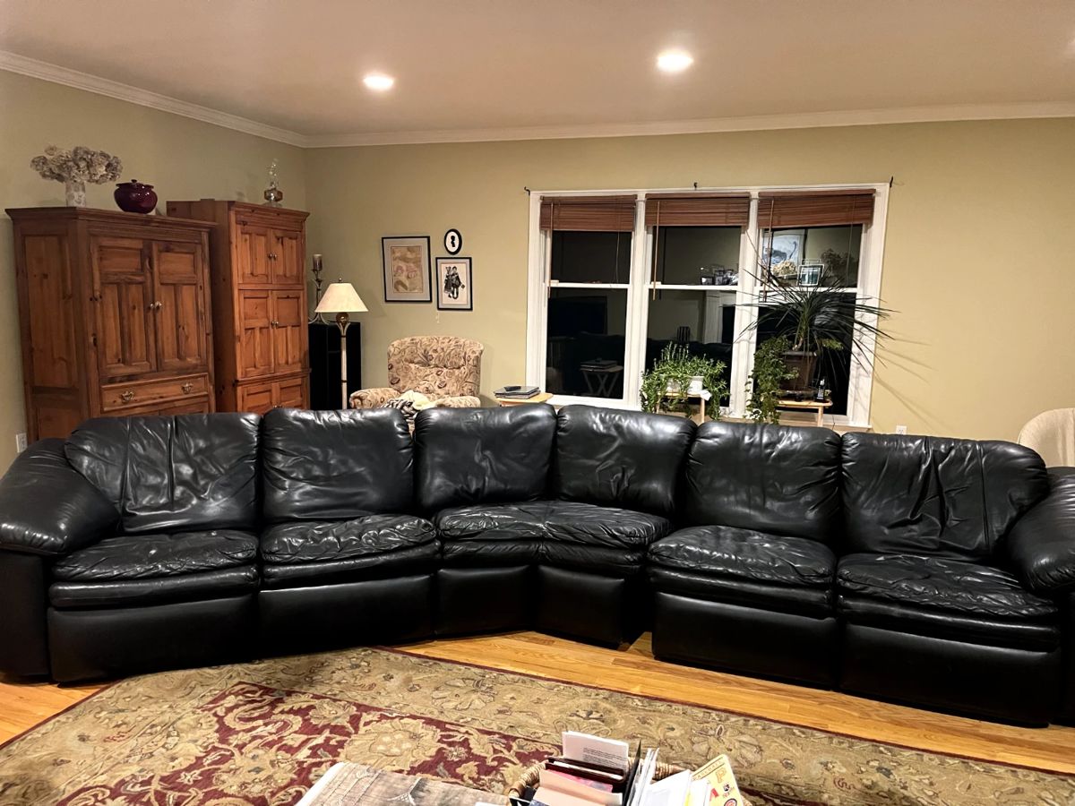 Large black leather sectional.  This is 3 pieces that can be separated.  You can remove the middle piece to make a straight leather sofa, and each of the end pieces have a lever to lift a footrest up.  This sectional is a high-end leather in excellent condition.  14 feet long or 10 feet long without the middle piece.  The depth is 38 inches.  