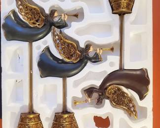 Set of 3 decorative angel finials in original box.  They are made of resin with an antique brass finish.  In excellent condition.  Sizes are 16", 18", and 21".  