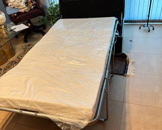 #44 - $100.00  -  Leather Ottoman hide-away rolling bed 16H x 46L x 28W