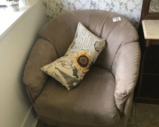 Two tan plush swivel chairs. 